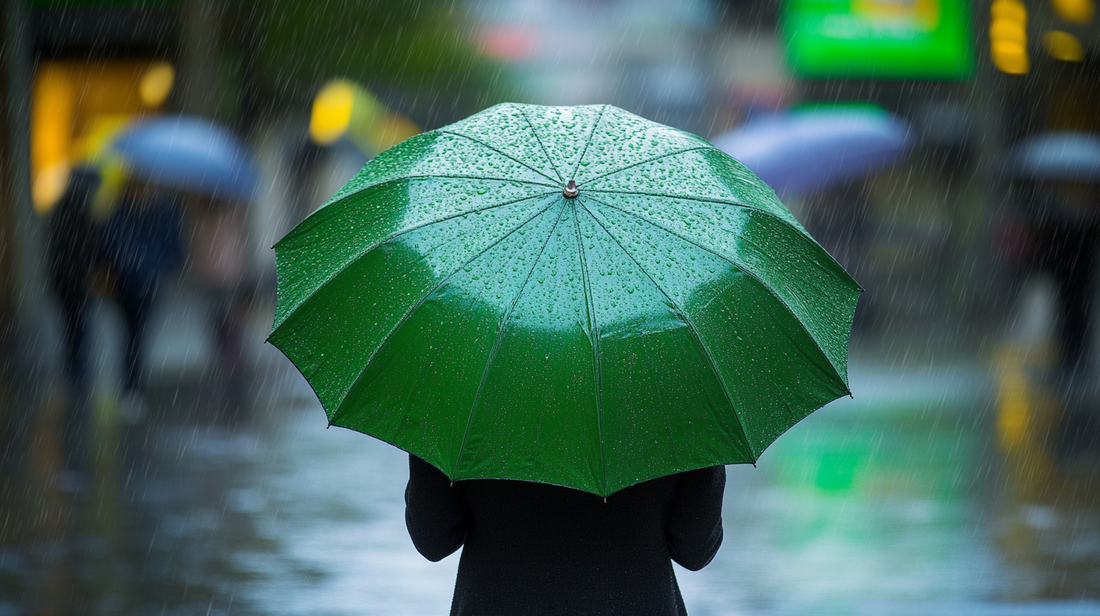 A woman standing in the rain, holding a green umbrella.